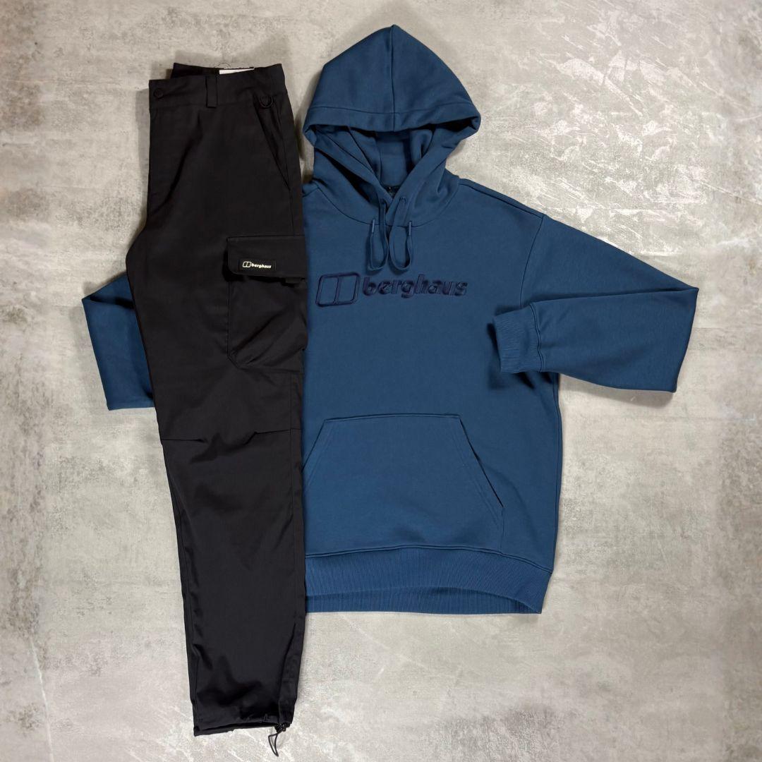 Berghaus 'Dark Blue' Logo Hoodie & Cargo Pant Tracksuit for men, flat lay on a grey concrete surface of the dark blue logo hoodie with matching black cargo pant