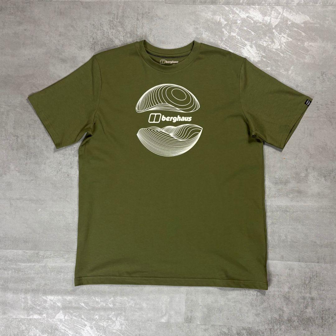 Berghaus 'Dark Green' Curvature Essential T-Shirt for men, flat lay on a grey concrete surface of the dark green crew neck tee with white contour-line graphic and Berghaus logo on the chest