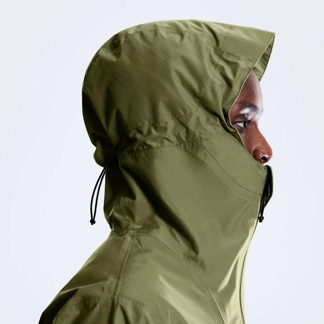 Berghaus 'Dark Green' Deluge Pro 3.0 Jacket for men, close-up on model of the dark green hood with drawcord adjuster, part of the 'Dark Green' Deluge Pro 3.0 Jacket & Cargo Pant Tracksuit