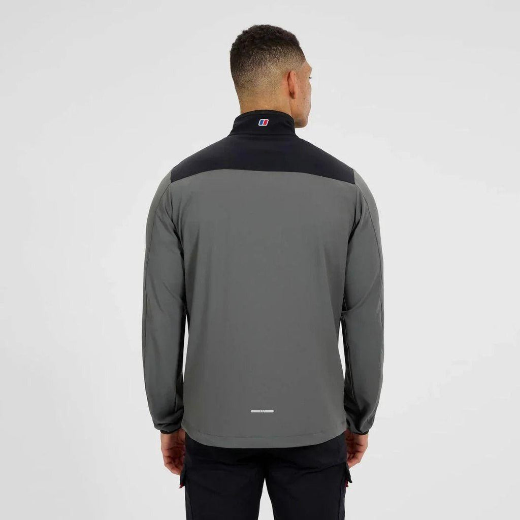 A man viewed from the back wearing a Berghaus dark gray and black long-sleeve athletic quarter-zip jacket, set against a plain light gray studio background.