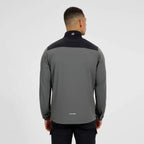 A man viewed from the back wearing a Berghaus dark gray and black long-sleeve athletic quarter-zip jacket, set against a plain light gray studio background.
