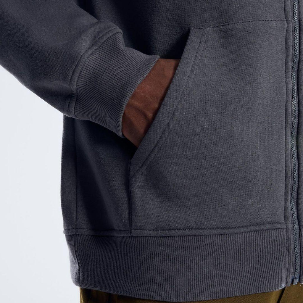 Berghaus 'Dark Grey' Logo Zip-Up Hoodie for men, close-up on model of the front hand pocket and ribbed hem of the dark grey zip-up hoodie