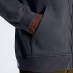 Berghaus 'Dark Grey' Logo Zip-Up Hoodie for men, close-up on model of the front hand pocket and ribbed hem of the dark grey zip-up hoodie