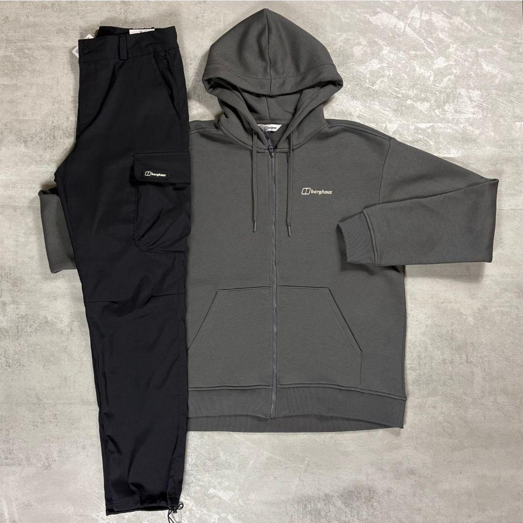 Berghaus 'Dark Grey' Logo Zip-Up Hoodie & Cargo Pant Tracksuit for men, flat lay on a grey concrete surface of the dark grey full-zip hoodie with matching black cargo pant