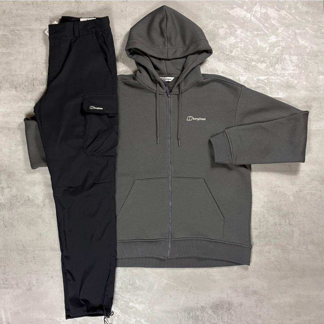 Berghaus 'Dark Grey' Logo Zip-Up Hoodie & Cargo Pant Tracksuit for men, flat lay on a grey concrete surface of the dark grey full-zip hoodie with matching black cargo pant