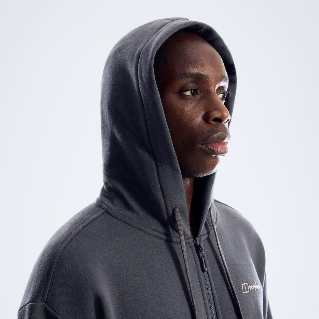 Berghaus 'Dark Grey' Logo Zip-Up Hoodie for men, close-up on model of the hood and full-zip front with the Berghaus logo on the chest