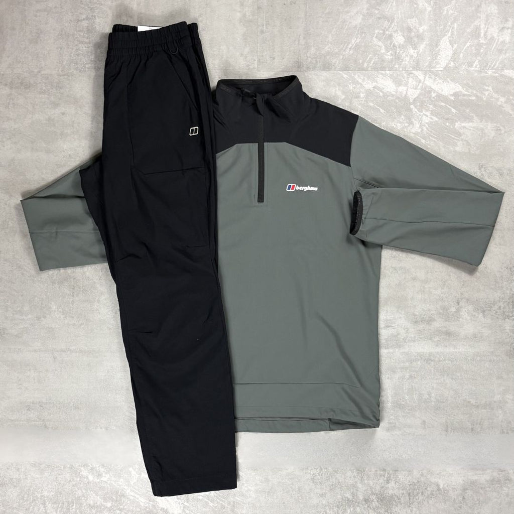 Gray and black jacket with a Berghaus logo and black pants on a gray surface