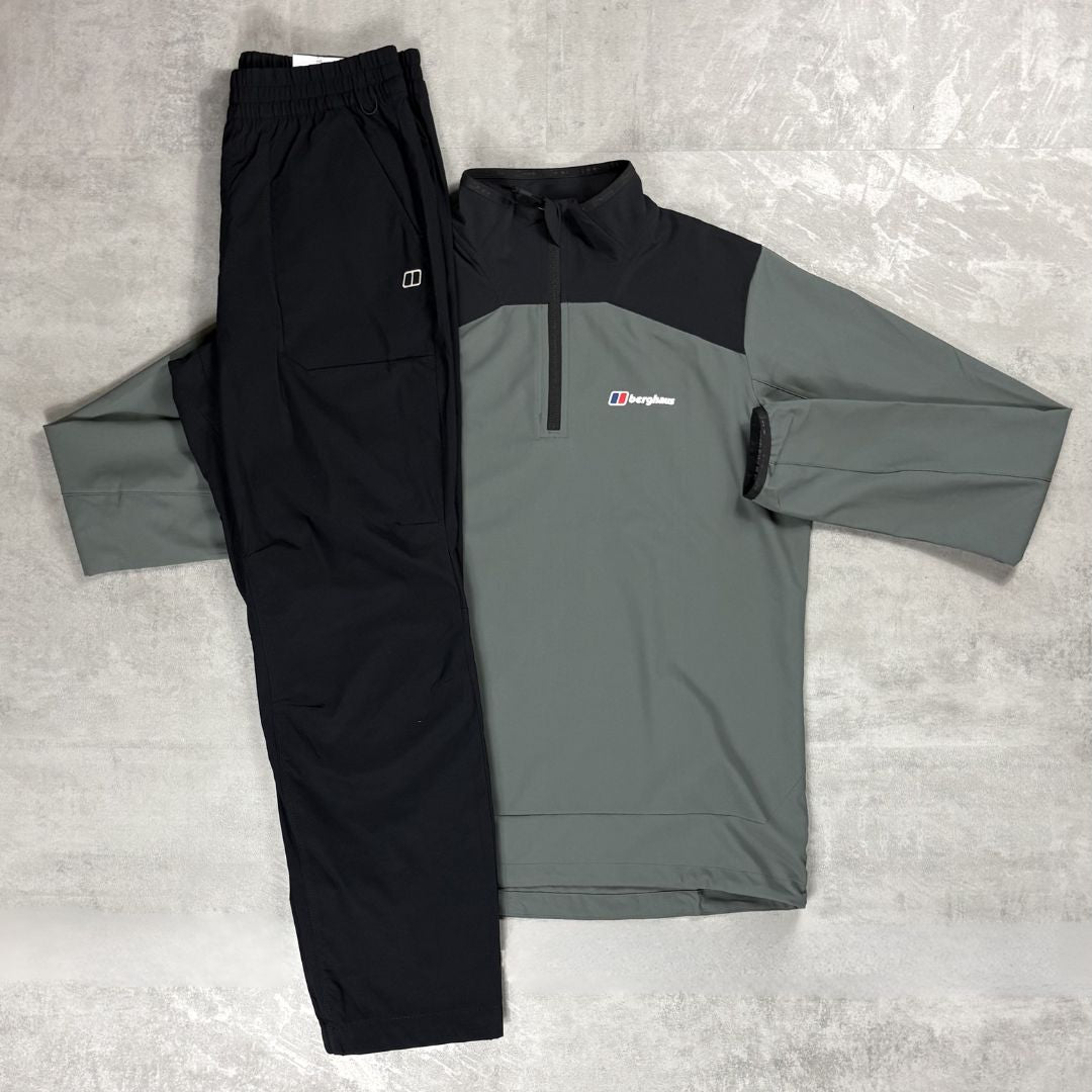Gray and black jacket with a Berghaus logo and black pants on a gray surface