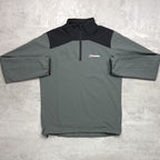 Gray and black pullover with a Berghaus logo on a light gray background