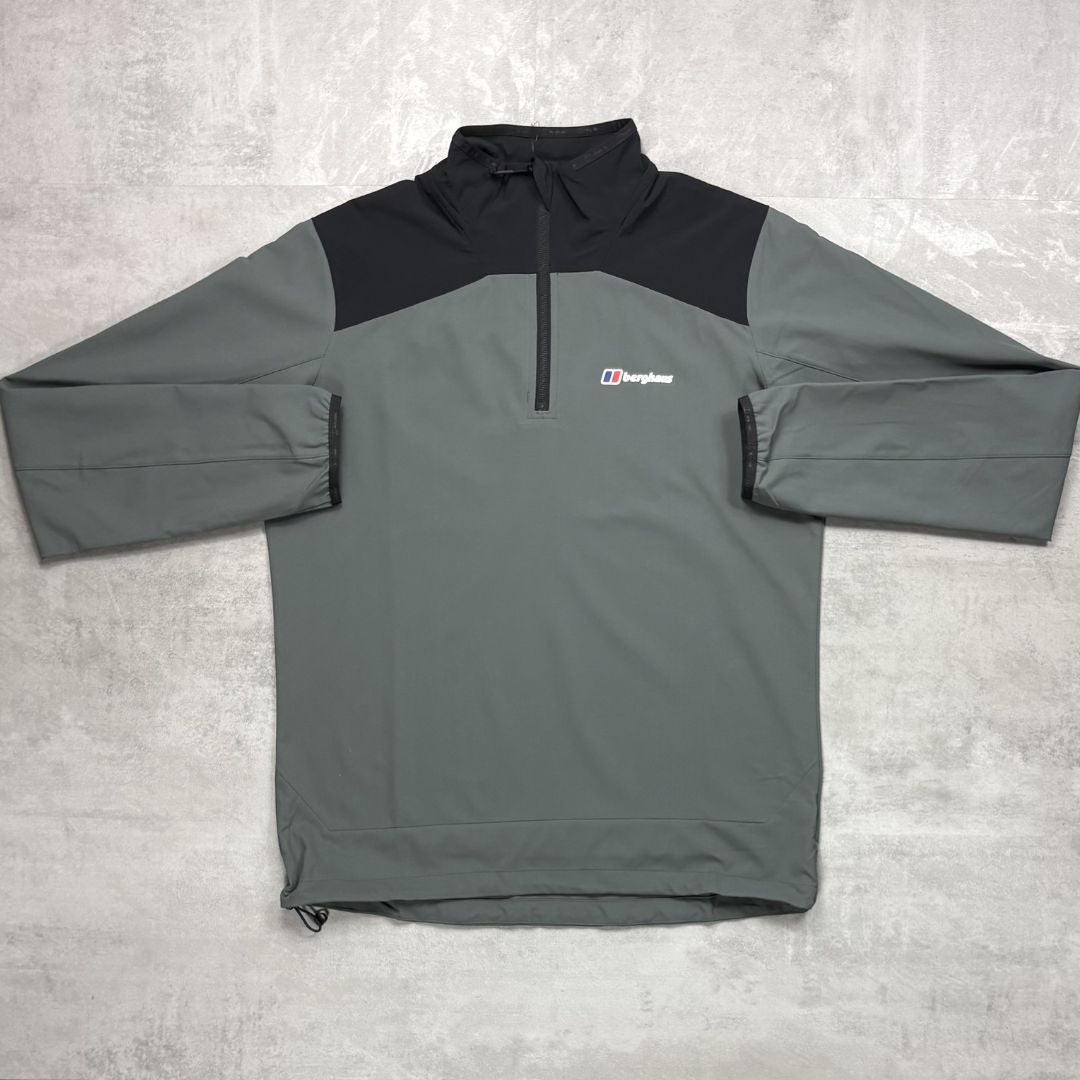Gray and black pullover with a Berghaus logo on a light gray background
