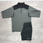 Grey and black Berghaus jacket with matching Berghaus shorts on a light gray background