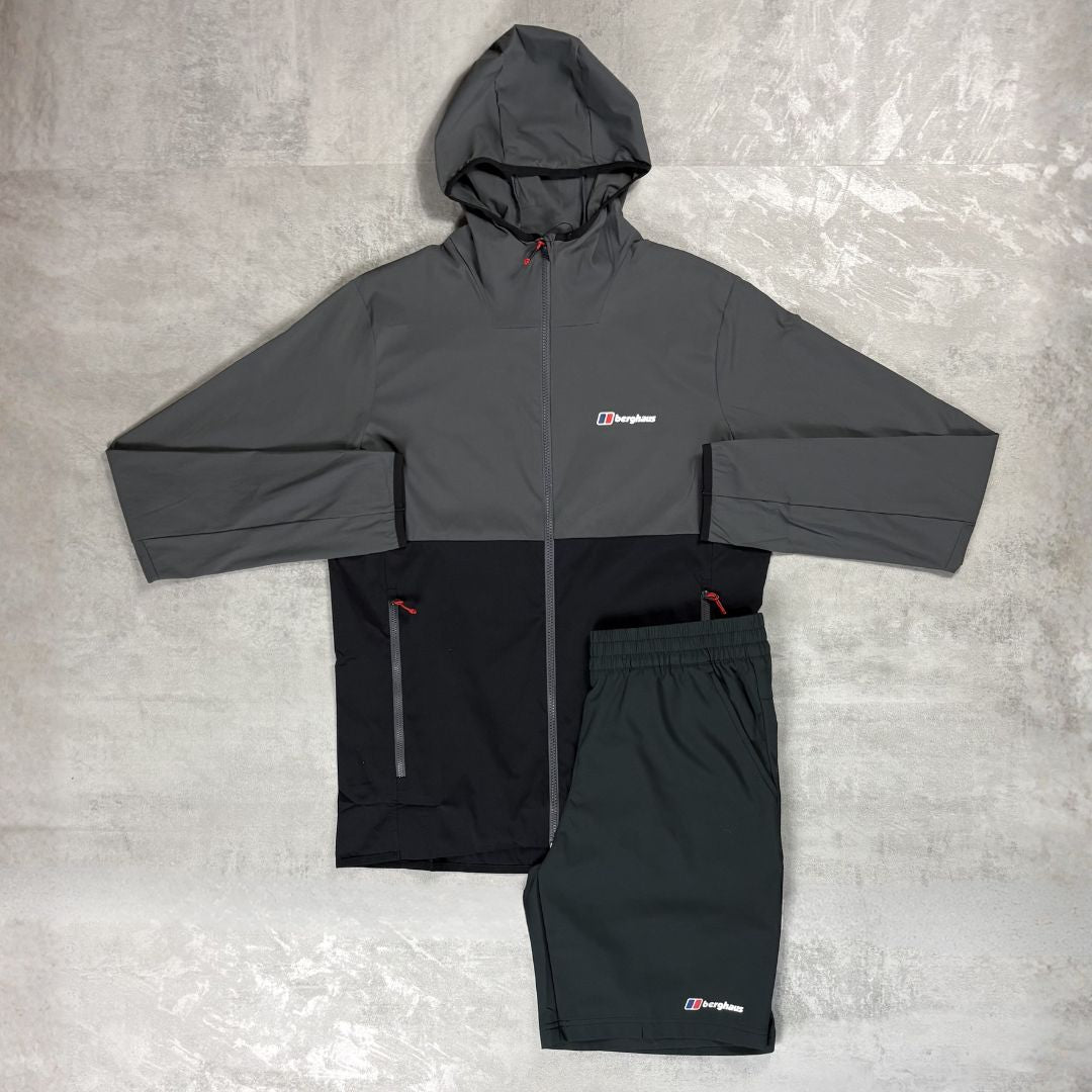Gray and black Berghaus jacket with matching pants on a gray surface