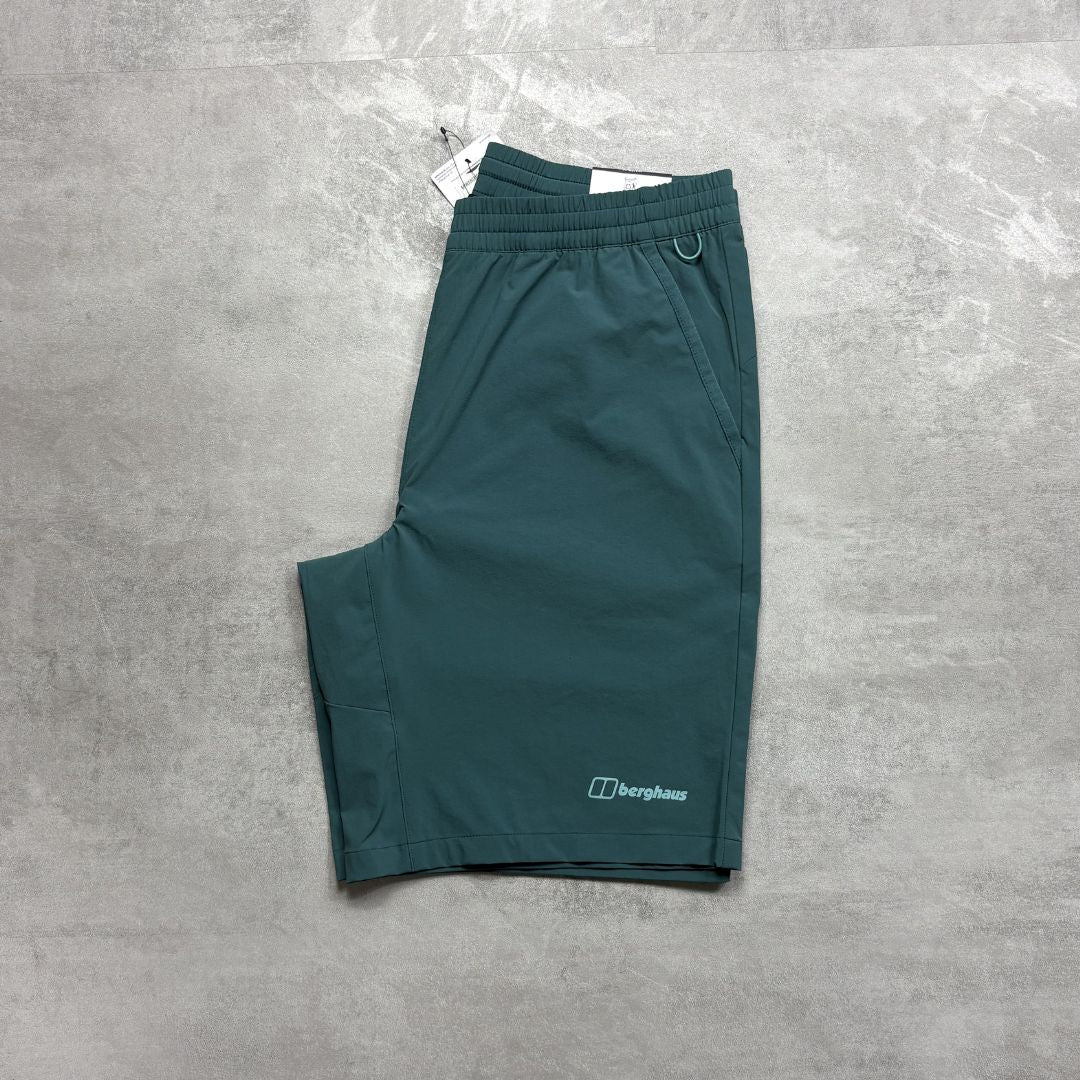 Teal shorts with a Berghaus logo on a gray textured surface