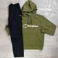 An olive green hoodie and black pants set from the brand Berghaus, laid flat on a textured gray concrete background. The hoodie features the white 'berghaus' logo across the chest.