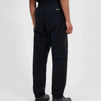 Person wearing black Berghaus pants on a white background