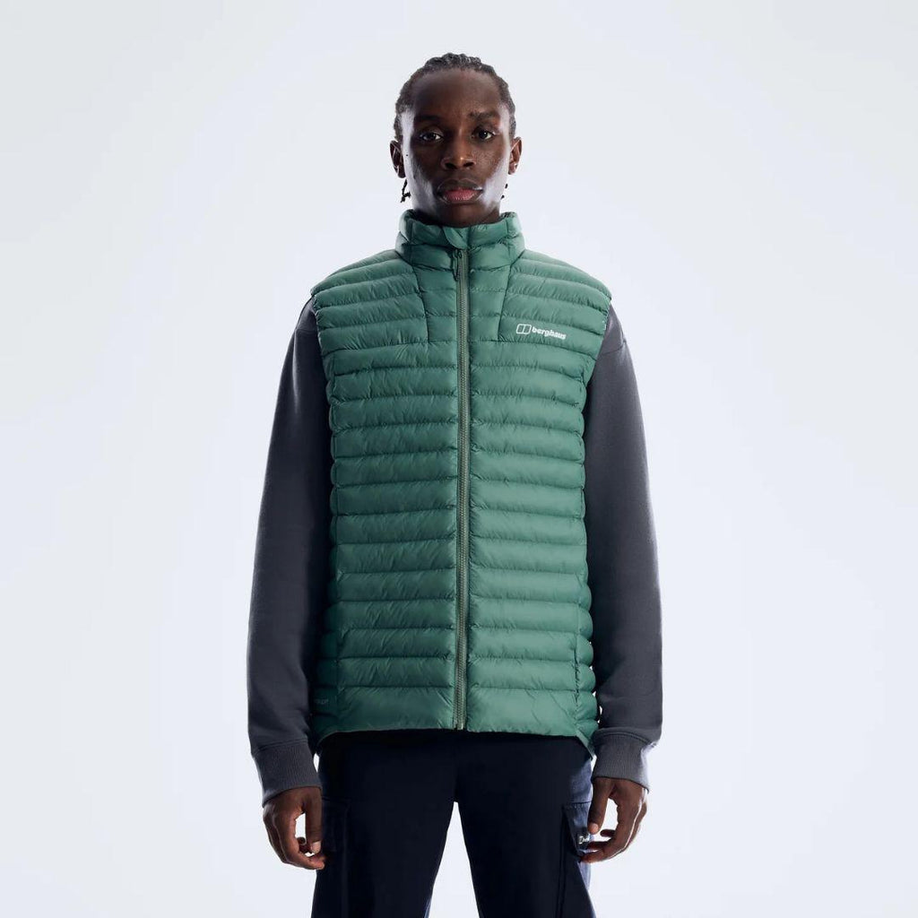 Berghaus Green Vaskye Gilet for men, front view on model of green quilted gilet with stand collar, full-zip front and Berghaus logo on the chest, worn over a dark long-sleeve top