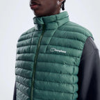 Berghaus Green Vaskye Gilet for men, close-up on model of the stand collar and Berghaus logo on the chest of the green quilted gilet
