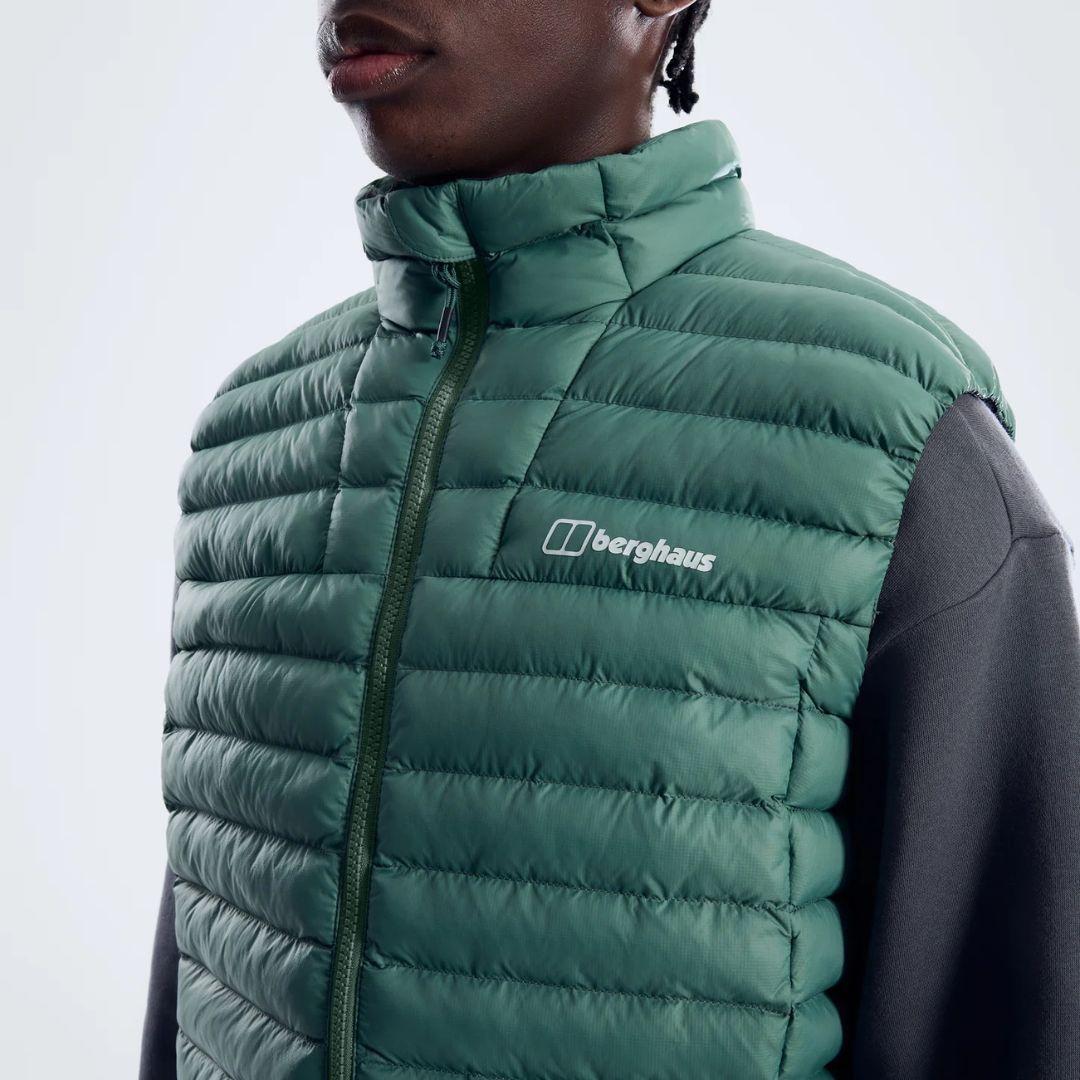 Berghaus Green Vaskye Gilet for men, close-up on model of the stand collar and Berghaus logo on the chest of the green quilted gilet