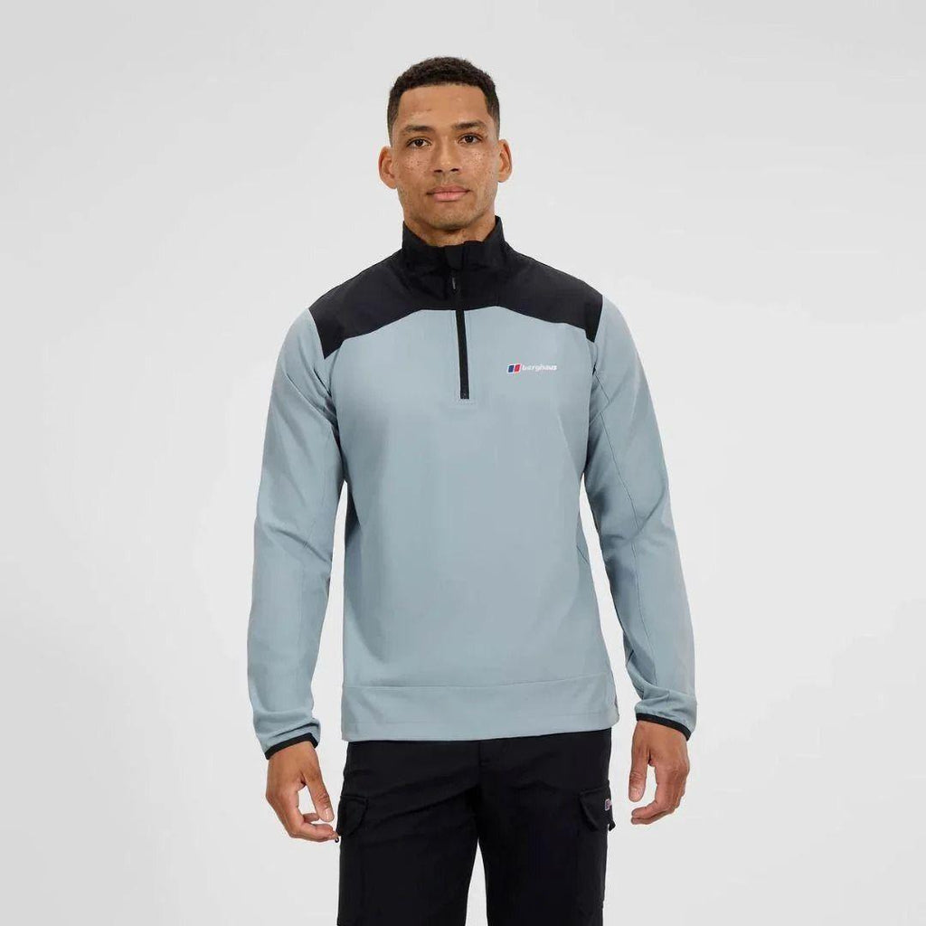 Man wearing a gray and black pullover with a Berghaus logo on a white background