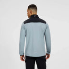 Person wearing a Berghaus grey and black jacket on a white background
