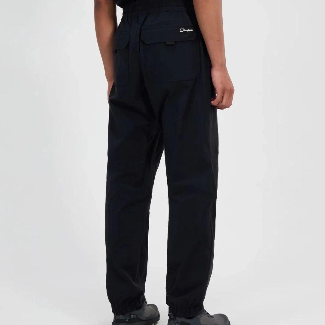 Person wearing black pants on a white background