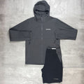 Dark gray jacket and black pants with a Berghaus logo on a light gray background