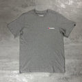 Berghaus Grey Class Logo T-Shirt for men, flat lay on a grey concrete surface of the grey marl crew neck tee with small Berghaus logo on the chest and woven tab on the sleeve
