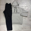 Berghaus Grey Logo Hoodie and Pant Tracksuit for men, flat lay of marl grey brushed fleece hoodie with Berghaus logo and matching black Explorer pant with adjustable waistband