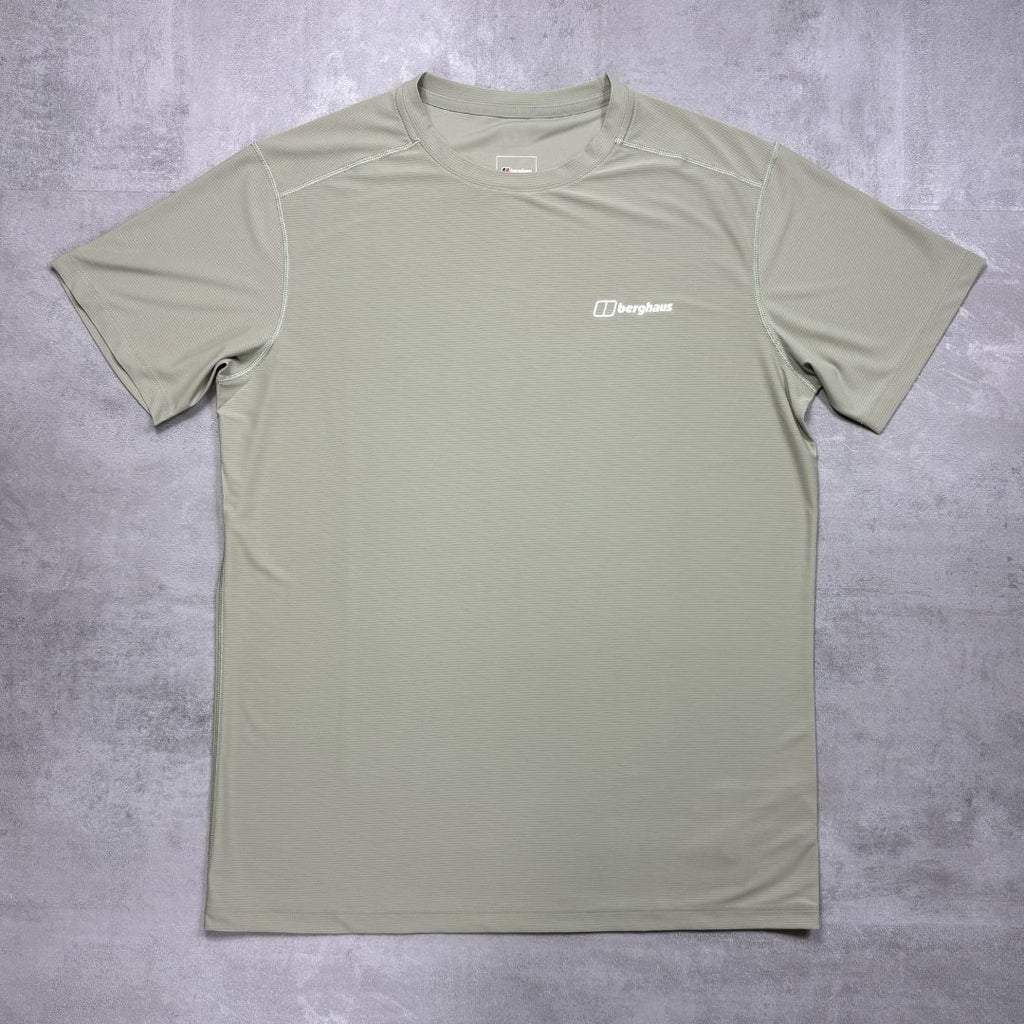 Green t-shirt with a Berghaus logo on a gray surface