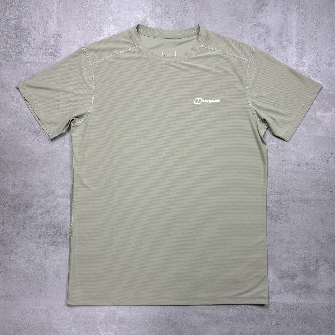Green t-shirt with a Berghaus logo on a gray surface