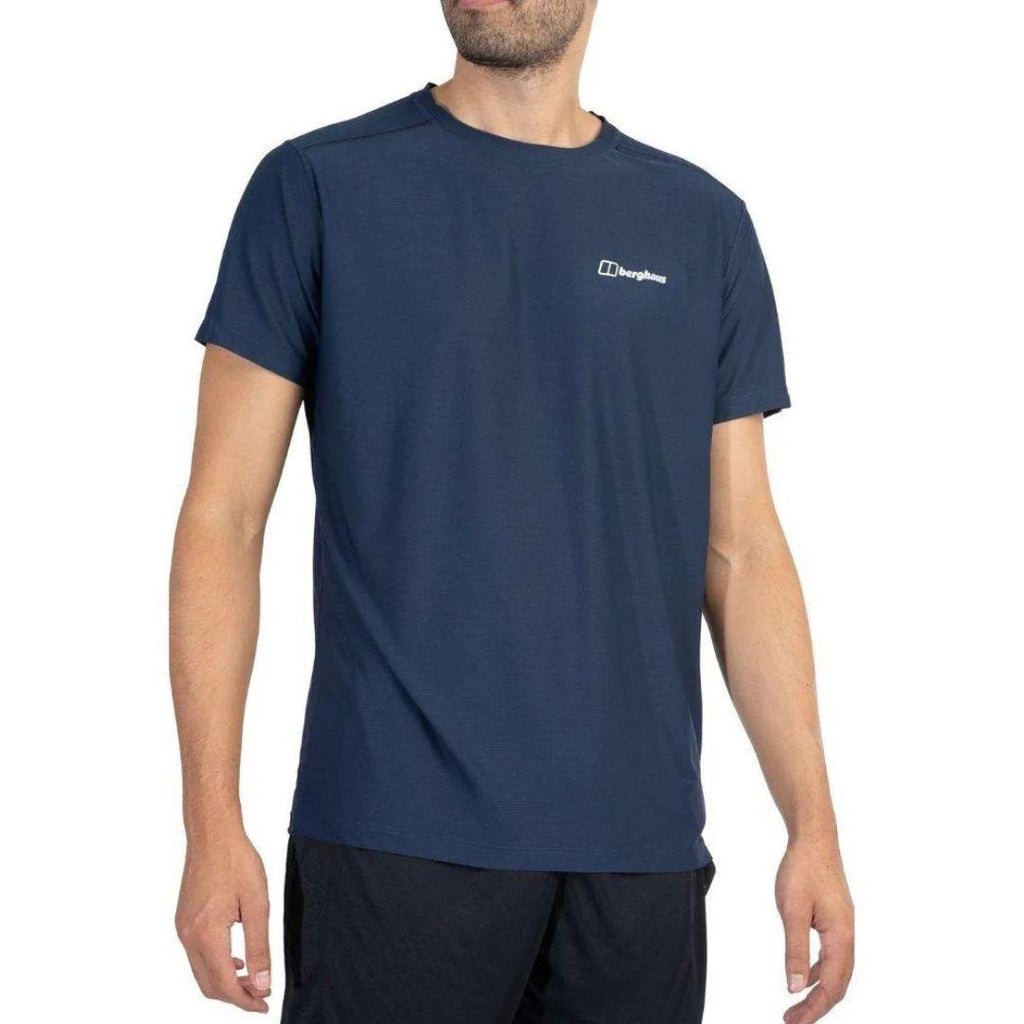 A man wearing a navy blue athletic t-shirt with a small white Berghaus logo on the left chest, shown against a plain white background.