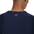 Close-up back view of a man wearing a navy blue crewneck t-shirt with a small white Berghaus logo centered below the collar.