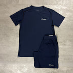 A navy blue short-sleeve athletic t-shirt and matching shorts set from the brand Berghaus, laid flat on a textured gray concrete surface.