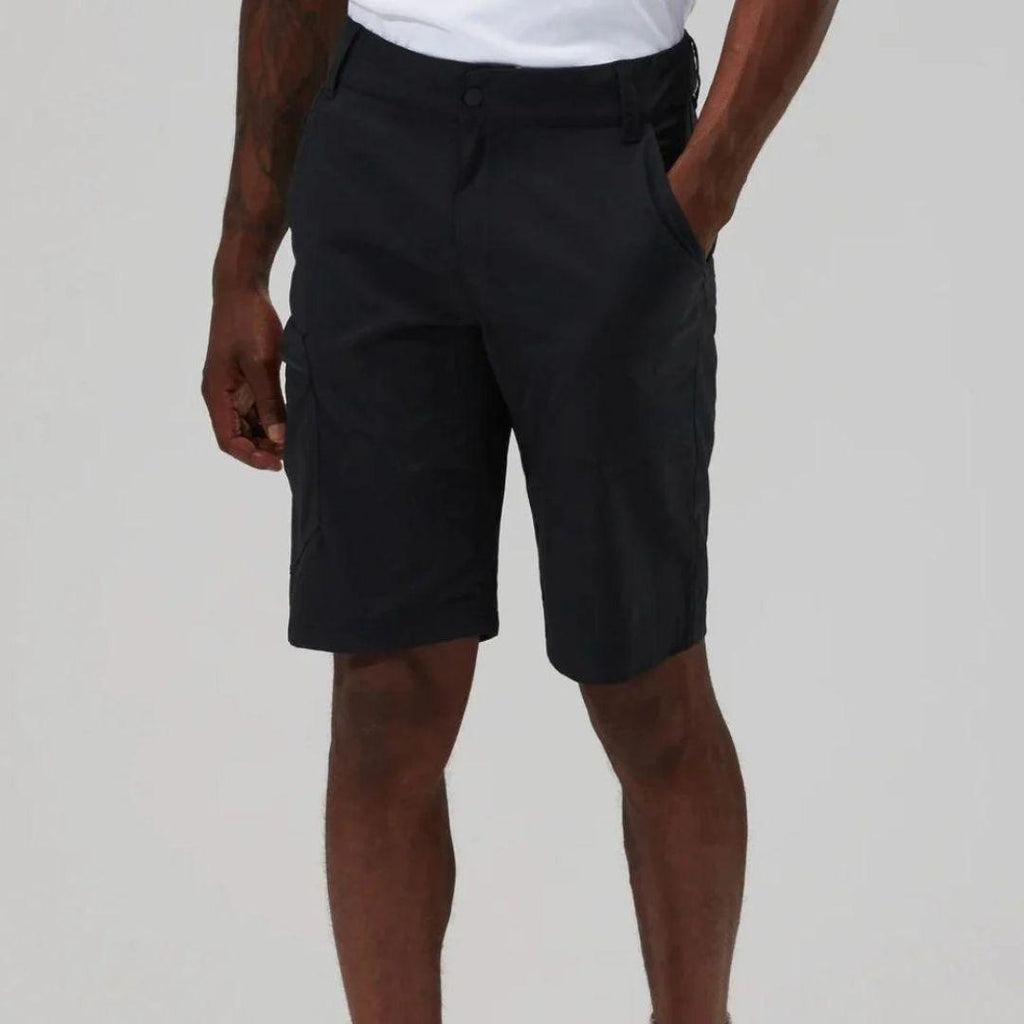 A person wearing black cargo shorts with a white t-shirt partially visible, shown from the waist down against a light gray studio background.