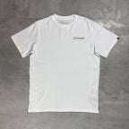 A white short-sleeve crewneck t-shirt with a small black 'berghaus' logo printed on the left chest, laid flat on a textured gray concrete surface.