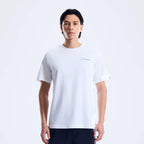 A man wearing a white short-sleeve crewneck t-shirt with a small gold Berghaus logo on the left chest, paired with dark pants, against a plain white studio background.