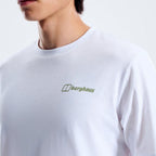 A close-up of a person wearing a white crewneck t-shirt with a small green and white Berghaus logo on the left chest, set against a plain light gray background.