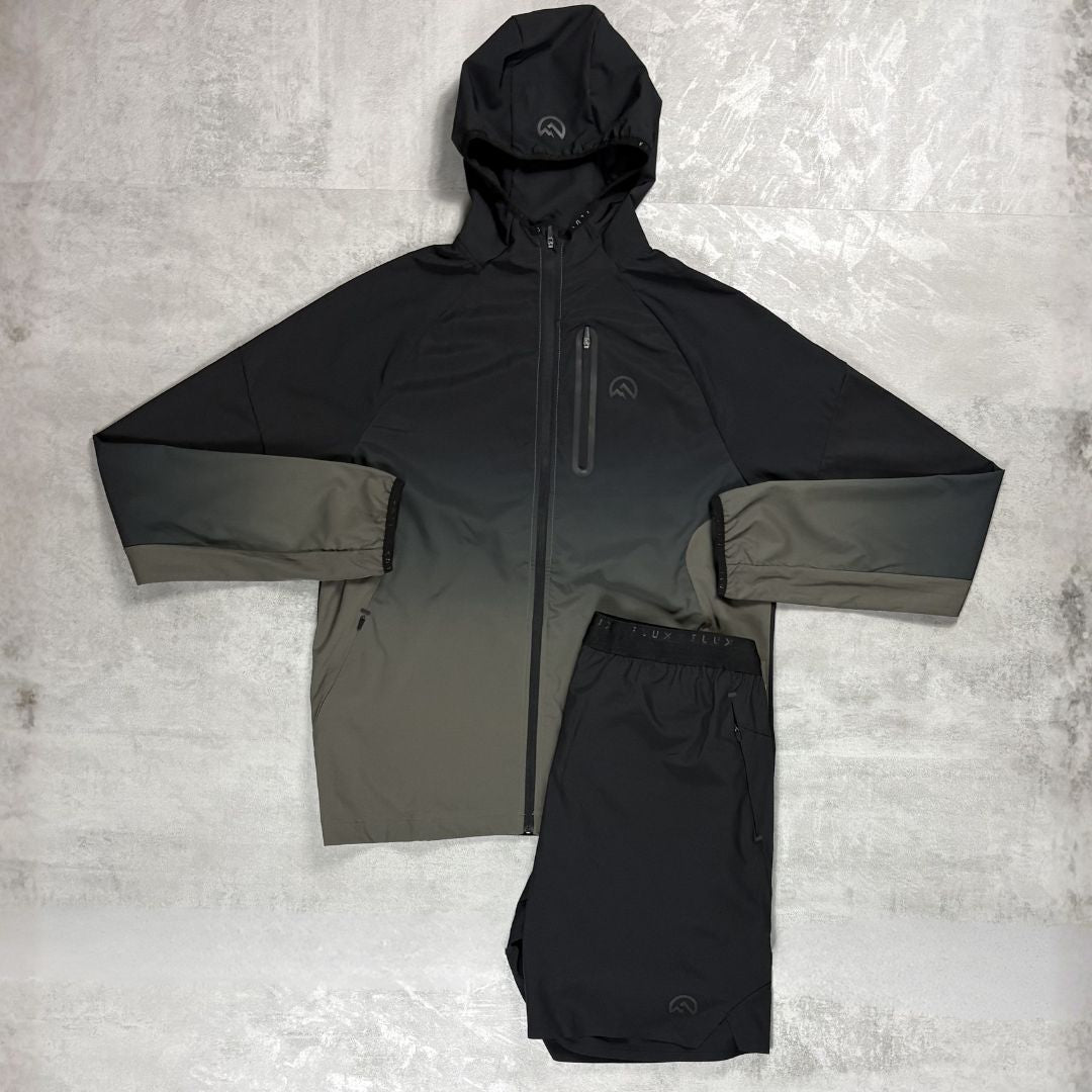 Black and grey Flux jacket with a hood on a textured grey background