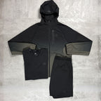 Flux Black raincoat, shirt, and shorts set on a textured gray background