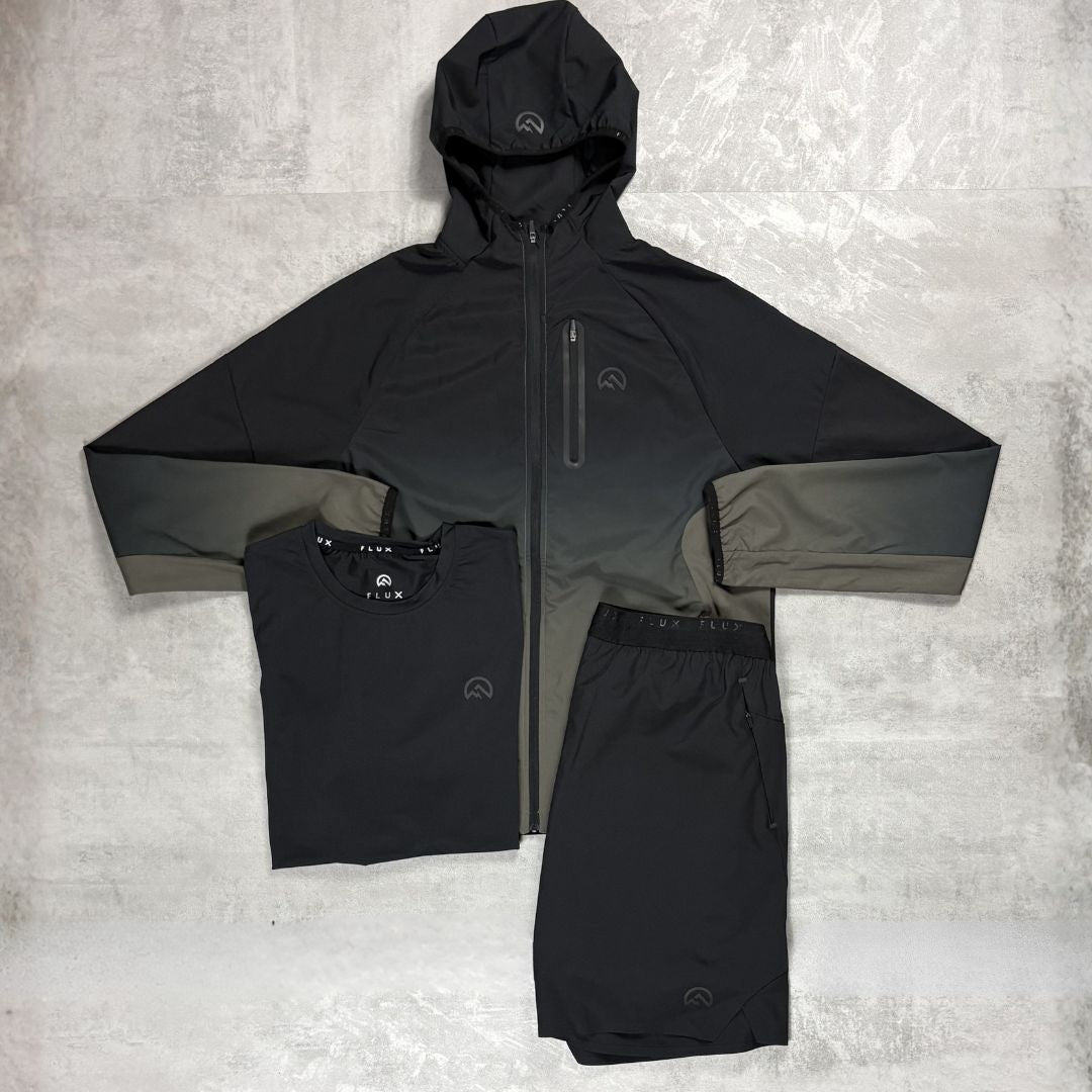 Flux Black raincoat, shirt, and shorts set on a textured gray background