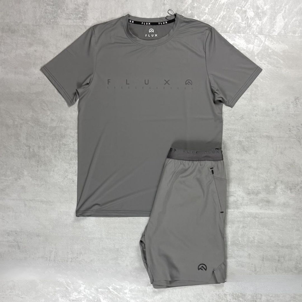 Gray athletic shirt and shorts set with 'Flux' branding on a textured gray background