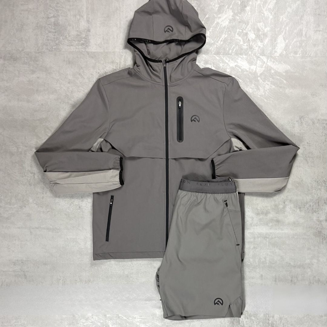 Flux Grey raincoat and pants set on a textured gray background
