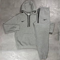 Nike Grey Club Fleece Hoodie and Joggers Tracksuit for men, flat lay of marl grey cotton fleece pullover hoodie with drawcord hood and kangaroo pocket and matching cuffed joggers with black Nike swoosh