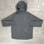 Gray hooded jacket with Nike logo on a textured surface