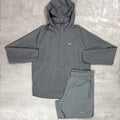 Grey Nike jacket and shorts set on a textured surface