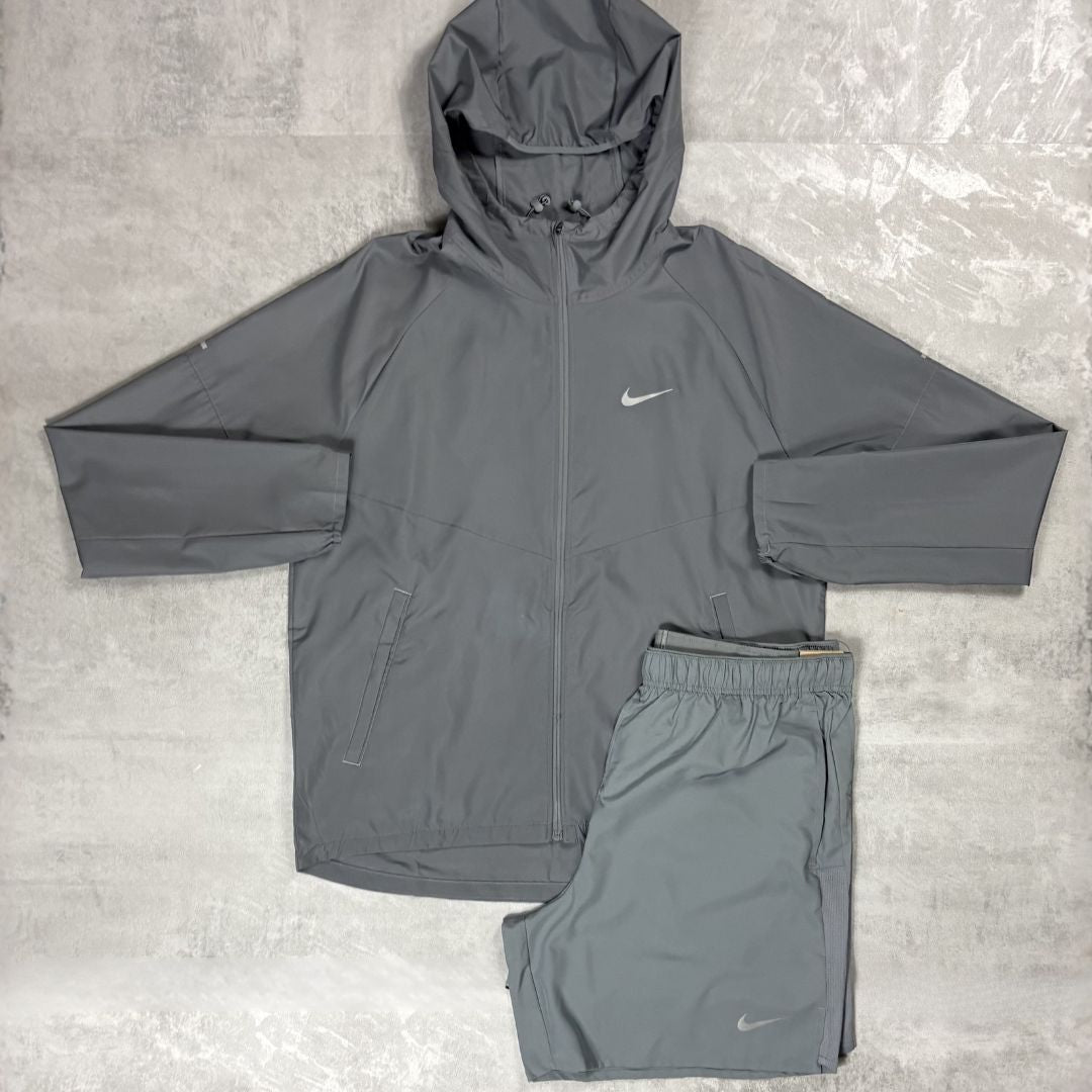 Grey Nike jacket and shorts set on a textured surface