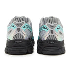 Pair of gray and black running shoes with a visible brand logo on a white background